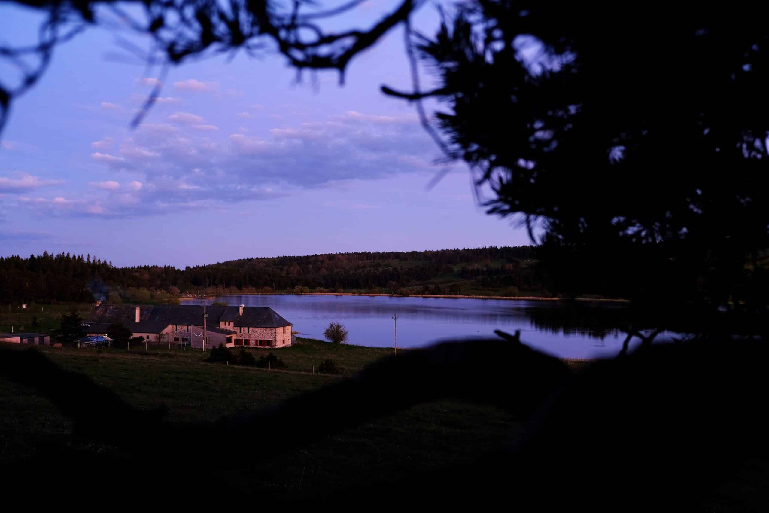 The volcanic stone facade of the Instants d'Absolu ecolodge blends seamlessly into the landscape.